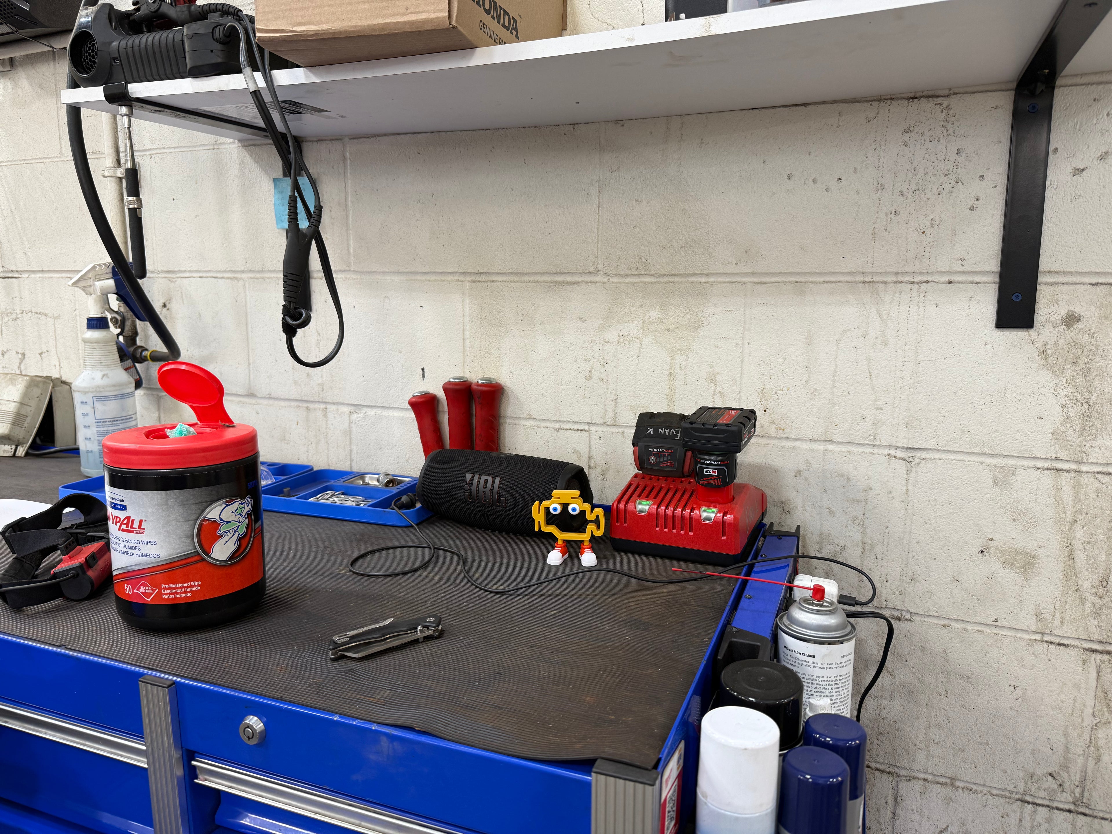 Workbench with tools and equipment in a workshop with a yellow icon standing forth