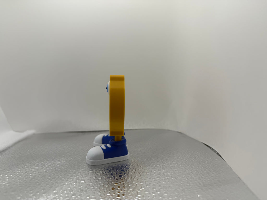 Small blue and white shoe with a yellow tag on a textured surface