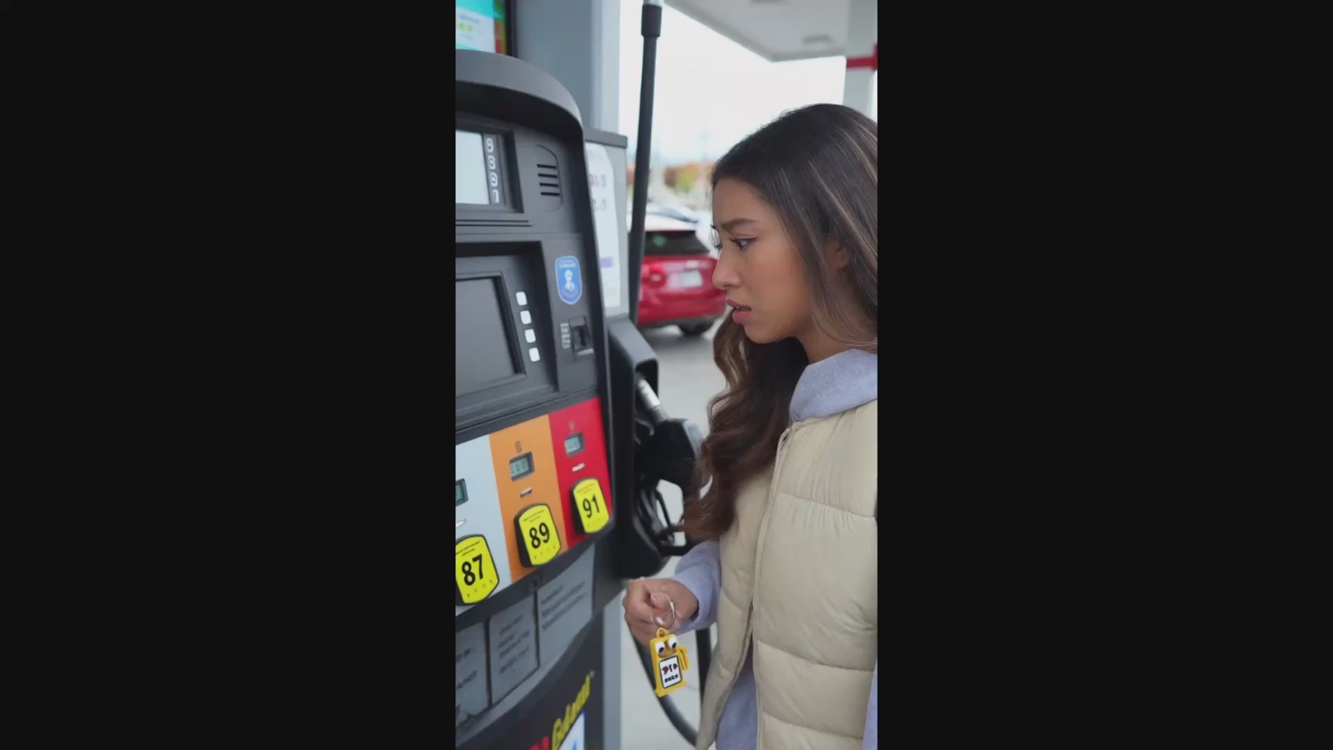Young Woman Confused Which Fuel To Pump Showing A Keychain Helping Her Decide Gas Type To Fill